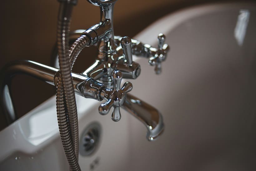 A close up of the faucet on a bathtub