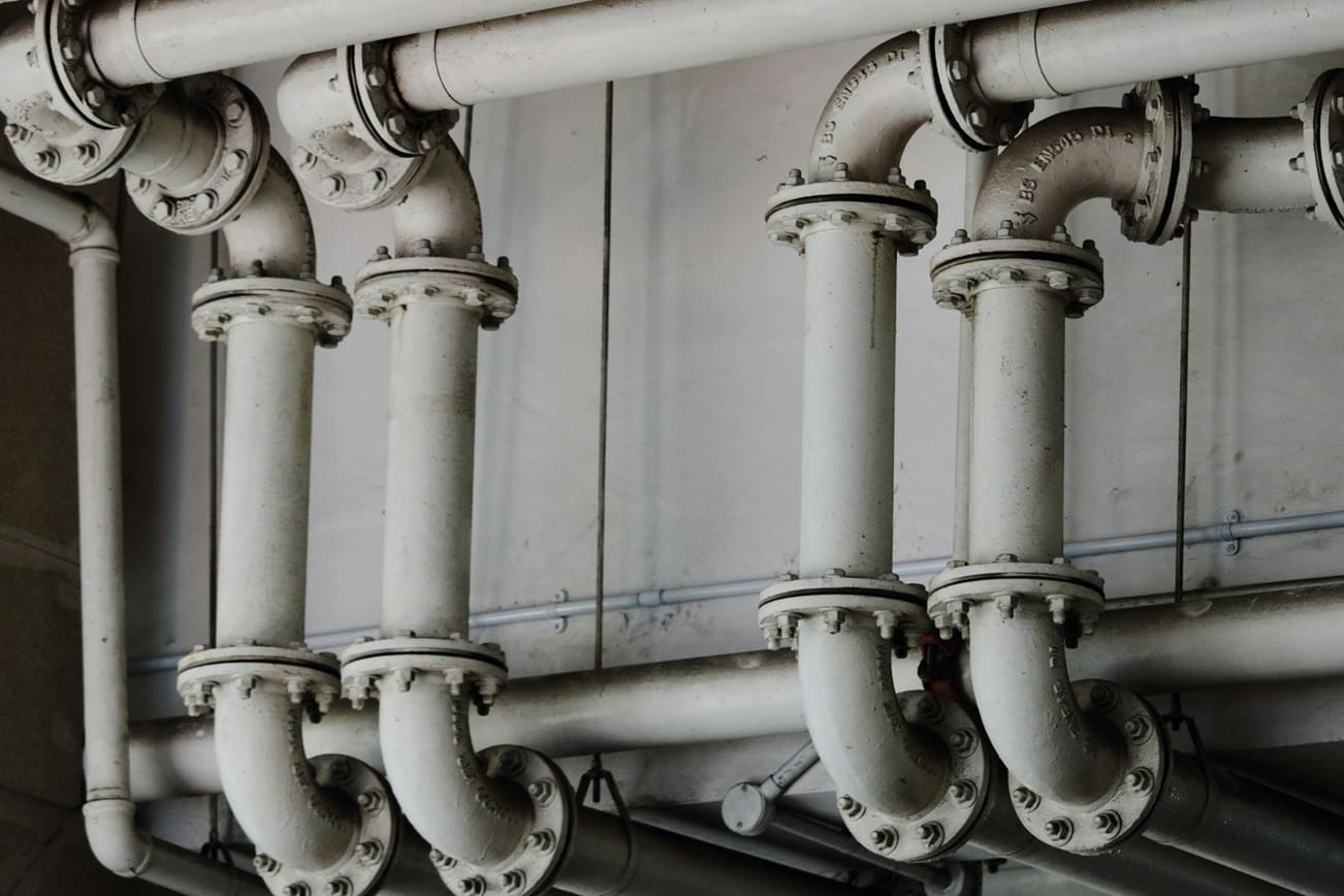 A bunch of pipes that are connected to the wall